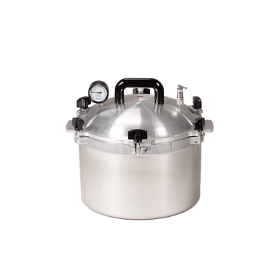 Small 15-quart All American non-electric pressure sterilizer, model 1915X, with a polished aluminum exterior, pressure gauge on top, and metal clamps