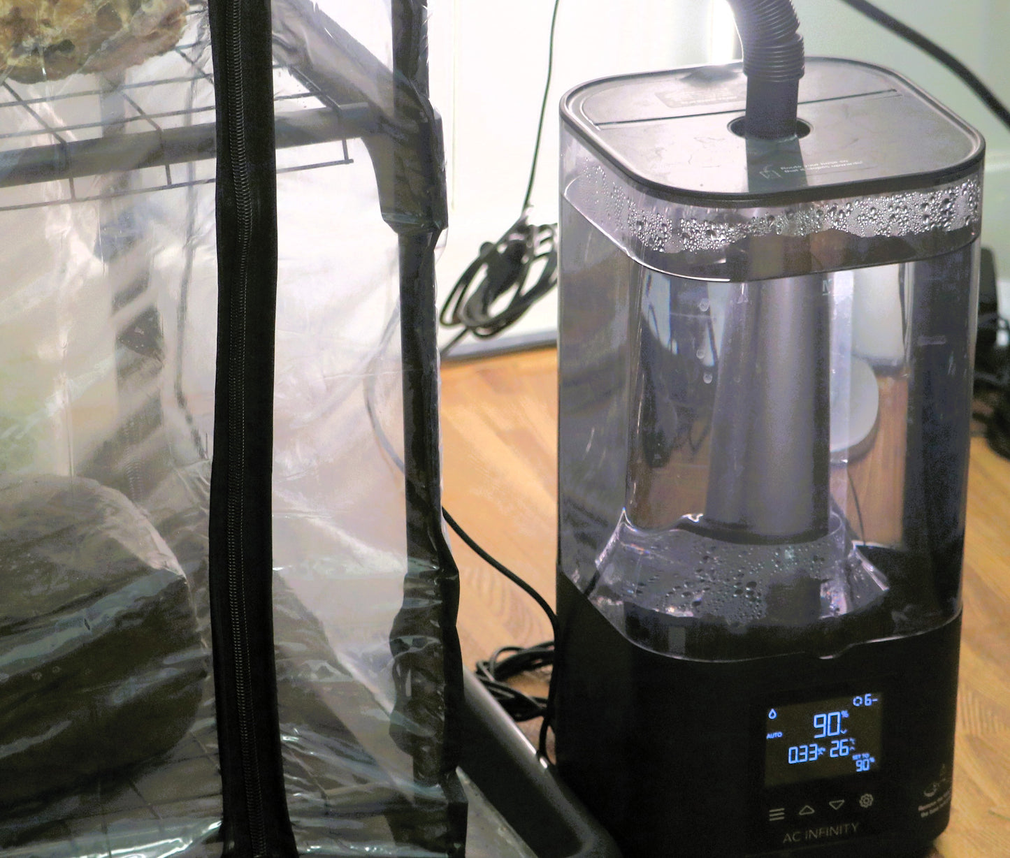 ultrasonic mushroom Humidifier with digital display on a wooden surface attached to a martha tent
