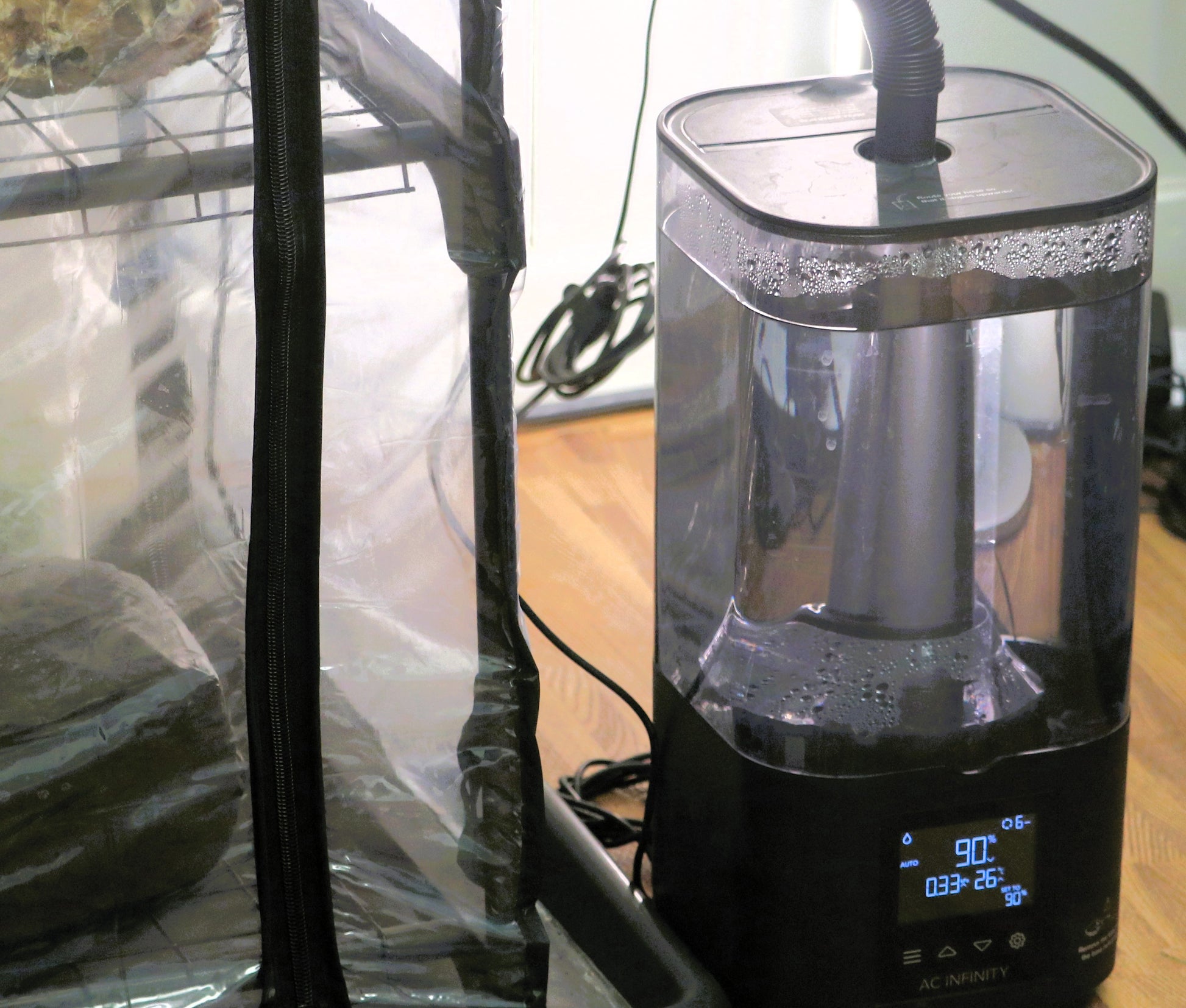 ultrasonic mushroom Humidifier with digital display on a wooden surface attached to a martha tent
